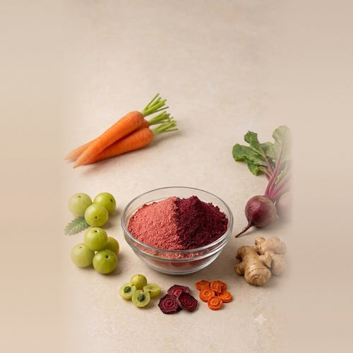 Nature Delights ABC powder (amla, beetroot and carrot) in a glass bowl with fresh carrots, amla, beetroot and ginger